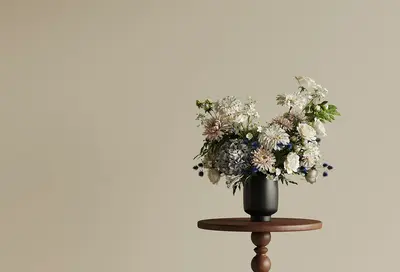 Floral Arrangement In Black Vase On Wooden Side Table 3d model